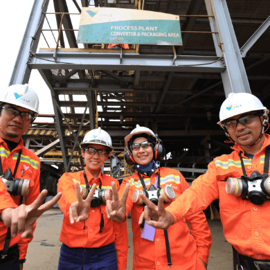 Four male and female Vale employees in uniform pose for a funny photo.