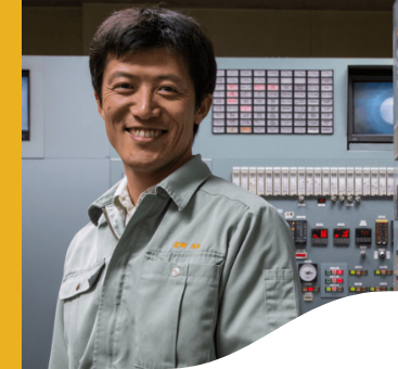 Vale employee in Japan. He is smiling and wears a gray uniform