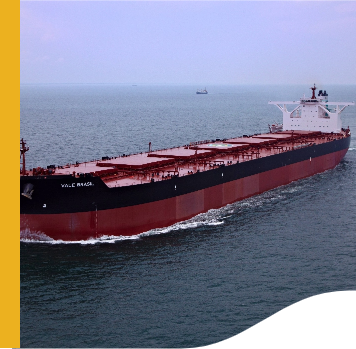 Large cargo ship, sailing on the high seas. It is red and has a black stripe.