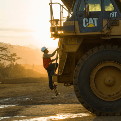 Uniformed Vale employee climbs on truck.