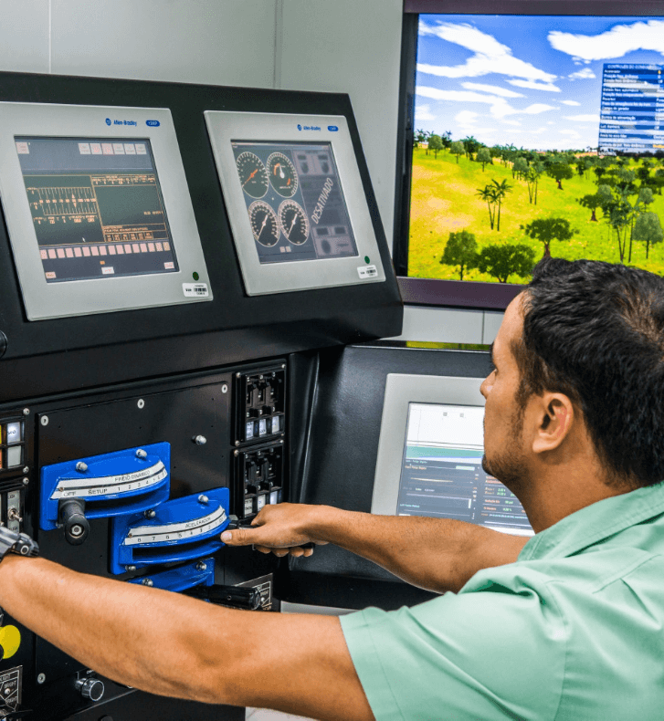 Vale employee is seated operating several monitors that are in front of him.