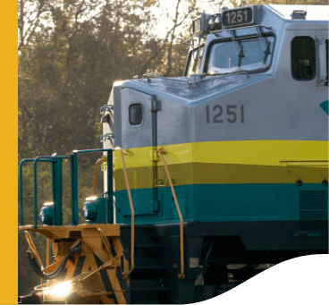 External image of the Vale train cabin. It is gray on top and has green and yellow stripes on the bottom. The number 1251 appears twice on the train's bodywork.