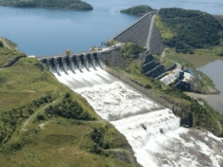 Photo of the Machadinho Hydropower Plant with a concrete structure and moving water passing through the structures.