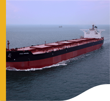 Image of a large cargo ship. It is red and has a black stripe, and is sailing on the high seas.